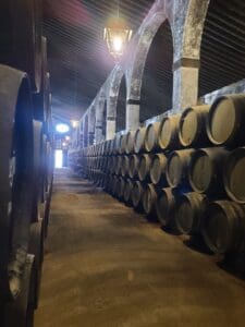 Aged barrels of Lustau sherry stacked in the historic bodega, exuding an old-world charm.