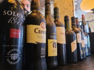 Array of Jerez wine bottles in a neat lineup.