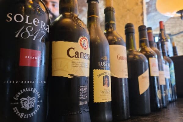 Array of Jerez wine bottles in a neat lineup.
