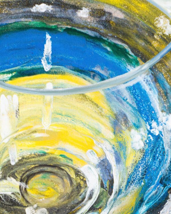 Detail of acrylic pour technique in a wine glass from a hybrid fluid realism painting.