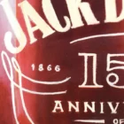 Close-up of the Jack Daniel's label in Monica Marquez Gatica's painting, showcasing the detailed oil typography.