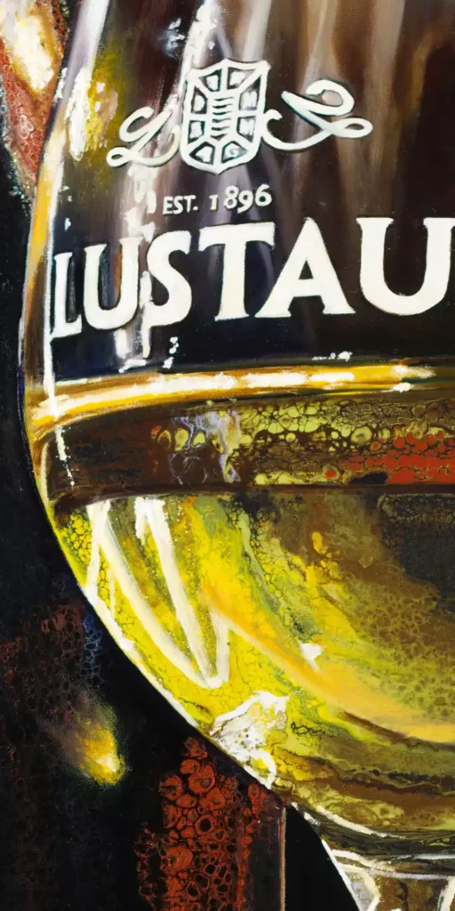 Close-up of a painted Lustau sherry glass with vibrant acrylic details and precise lettering against a dark backdrop