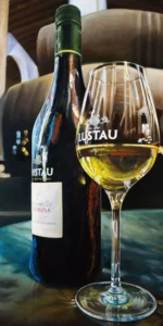 Painting of Lustau sherry bottle and glass on table capturing the essence of Jerez winemaking.