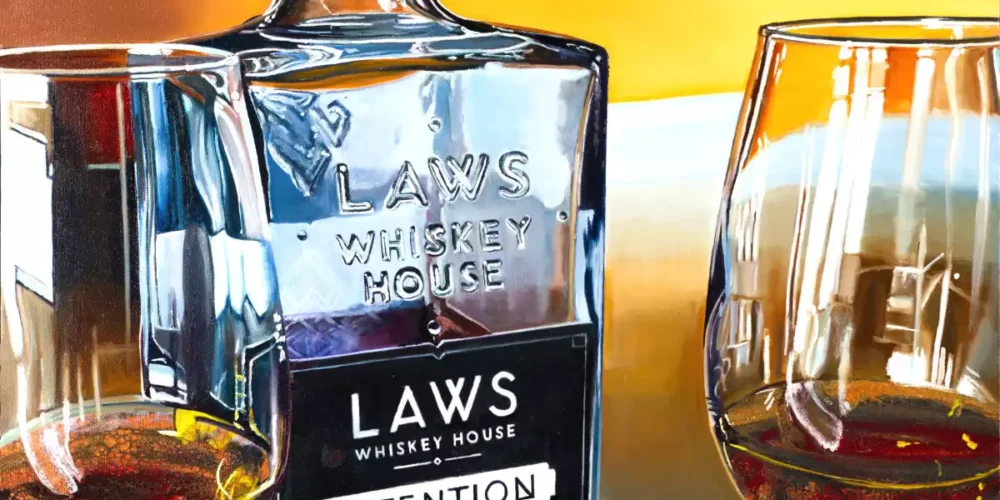 Hybrid fluid realism painting of LAWS Whiskey House's Intention Straight Bourbon Whiskey bottle with two filled glasses.