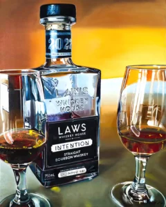 Hyper-realistic oil painting of LAWS Whiskey House's Intention Straight Bourbon Whiskey bottle with two filled glasses.