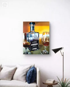 Painting of LAWS whiskey bottle and glasses displayed in a cozy living room.