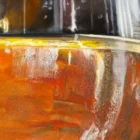 Close-up detail of a glass of sherry showing vibrant amber tones and intricate reflections