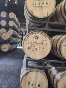 Close-up of bourbon whiskey barrels with visible batch numbers at LAWS Whiskey House.