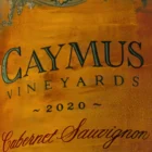 Close-up of Caymus bottle label in 'A Perfect Moment' painting by Monica Marquez Gatica