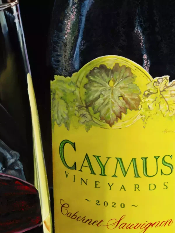 Detailed view of the Caymus Vineyards Cabernet Sauvignon label, highlighting the artistic rendering of the vineyard's emblem in Monica Marquez Gatica's hybrid fluid realism style.