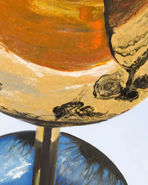 Close-up of a golden wine glass in Monica's painting, revealing the fluid acrylic pouring technique in the reflective surface of the glass.