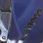 Close-up of a corkscrew placed next to the Caymus wine bottle, showcasing the detailed rendering of metal in Monica’s hybrid fluid realism style.