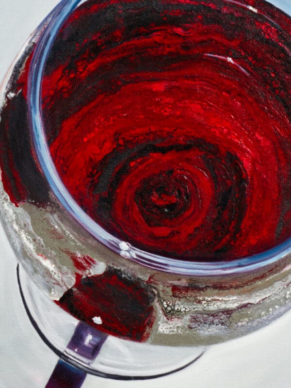 Close-up of crimson wine swirling in a glass with fine textures and light reflections.