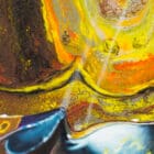 Close-up of vibrant acrylic pouring patterns from the painting "Spirit of the Soar," featuring gold, orange, and blue hues blending organically.