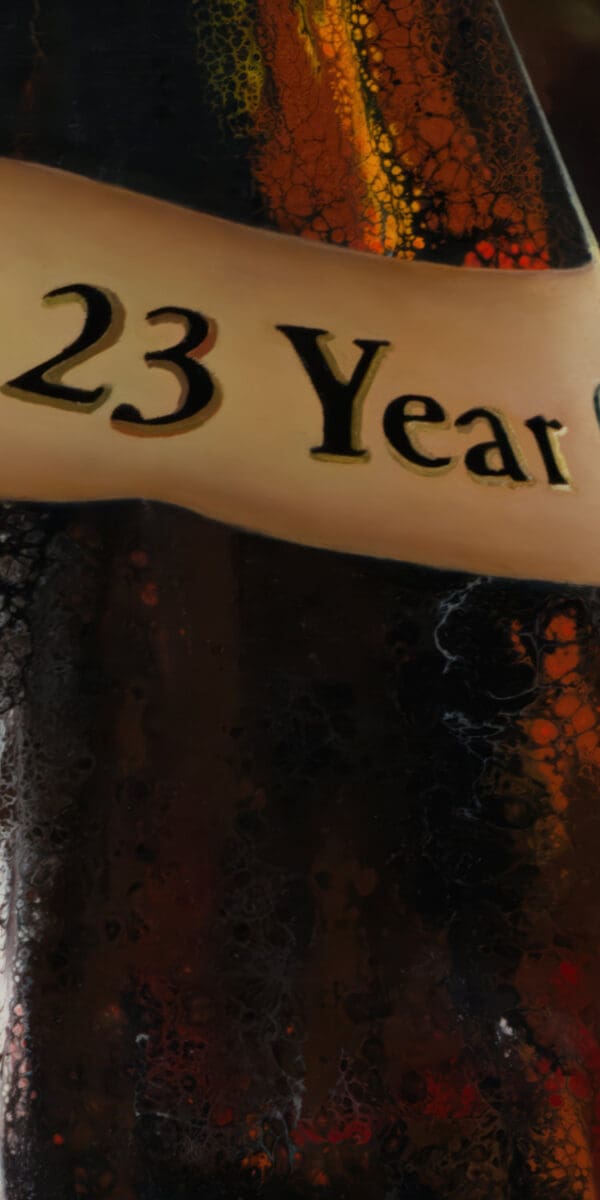 A close-up of the 23 Year Old label on a Pappy Van Winkle bottle, accentuating the textures and golden hues of the painting’s rich details.